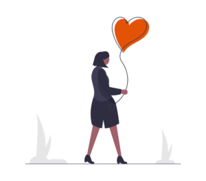 Eine Frau die einen Ballon in Herzform in der Hand hält